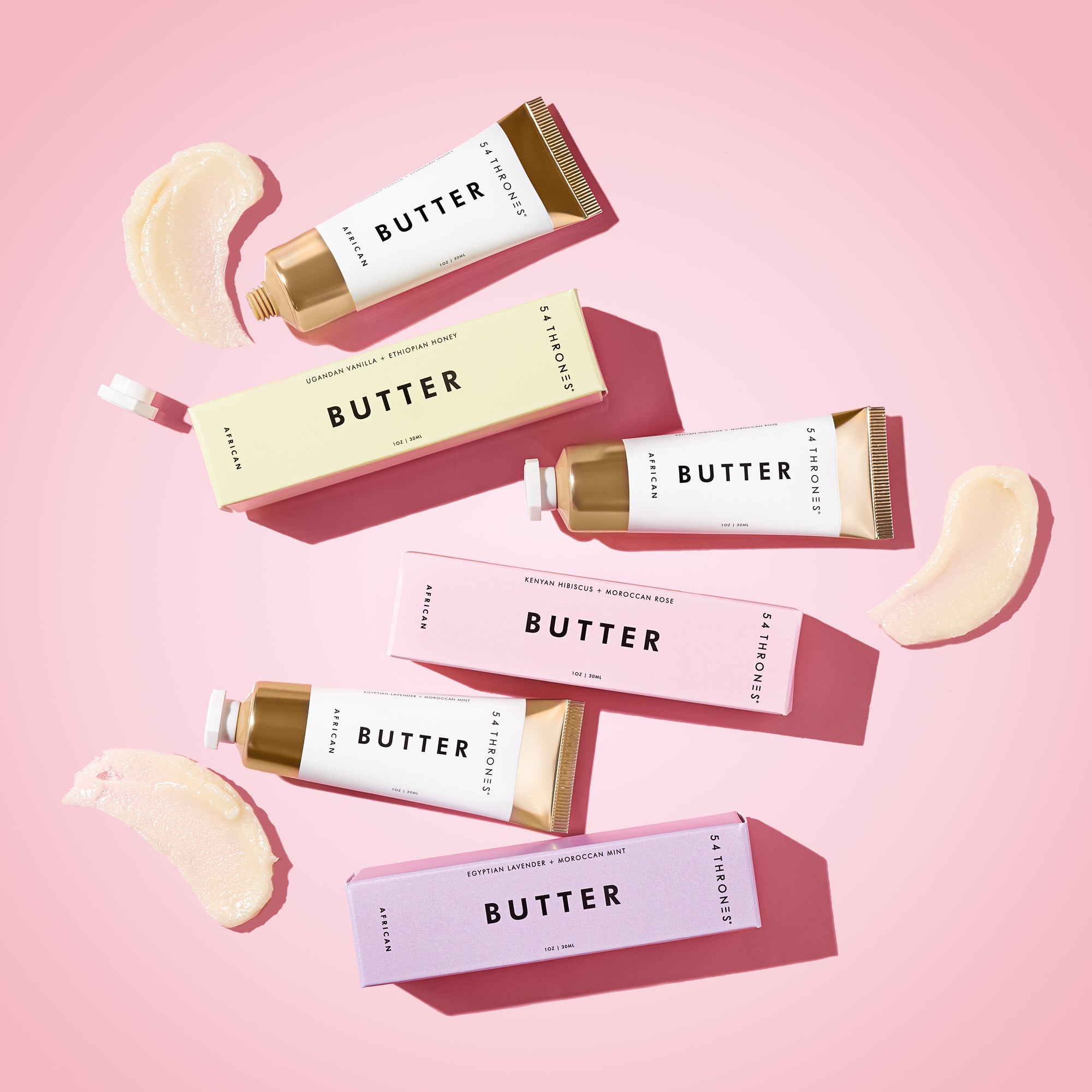 Three Mini Beauty Butter tubes and pastel-colored boxes against a pink background | 54 Thrones